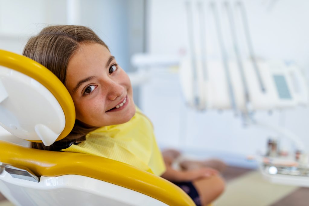 Cute Girl In The Dentist Chair Smiling